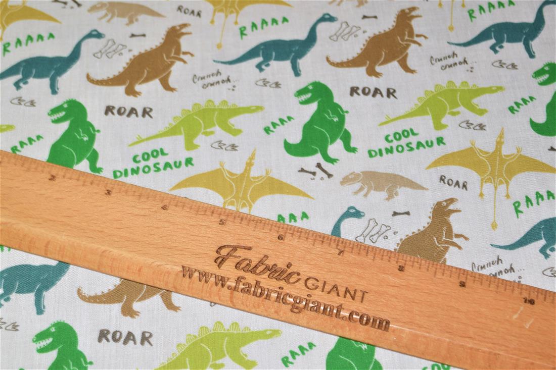 White Dinosaurs Printed Poly Cotton Fabric